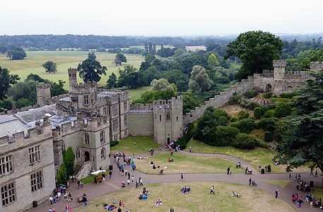 aerial photography of people standing and sitting near grey concrete castle during daytime thumbnail