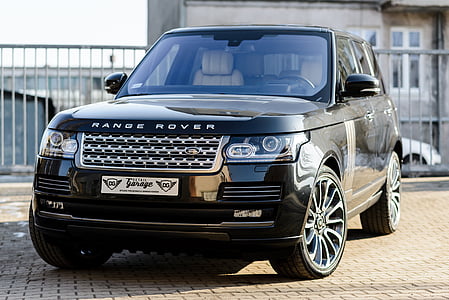 black Range Rover Sport SUV parked near gate thumbnail