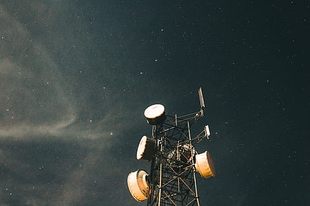 worm's eye photography of satellite during night thumbnail