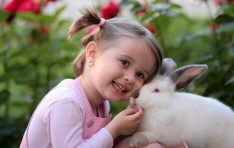 Girl Holding White Rabbit during Daytime thumbnail