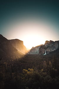 landscape photography of mountain canyon with trees and waterfall thumbnail