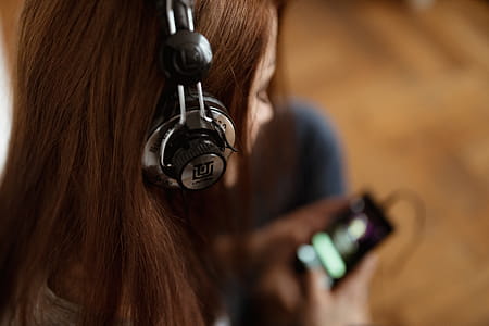 Beautiful young woman in headphones listening to music thumbnail