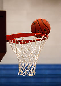 brown basketball on edge of white and red basketball hoop thumbnail