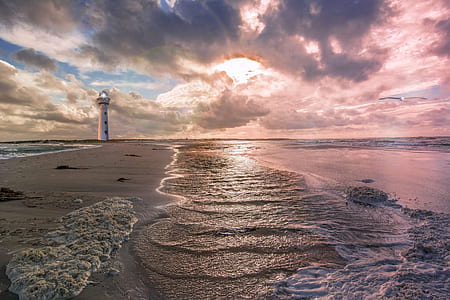 body of water beside white lighthouse thumbnail