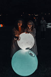 Two Women Holding Lighted Balls thumbnail