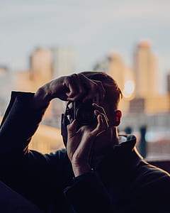 man taking photo using DSLR camera thumbnail