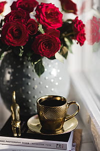 Gold cup of coffee and red roses bouqet thumbnail