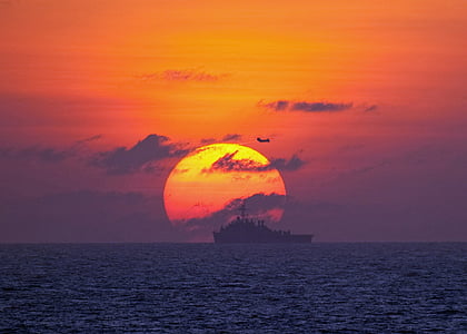 black ship on body of water during golden hour thumbnail