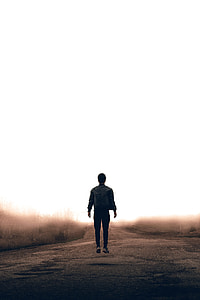 man standing on asphalt road thumbnail