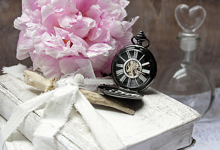 black pocket water beside bouquet of pink flowers thumbnail