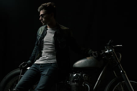 closeup photo of man leaning on standard motorcycle wearing black leather jacket thumbnail