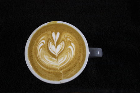 coffee art in ceramic mug on black surface thumbnail