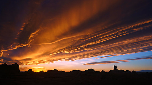 silhouette of hills under cloudy sky during golden hour thumbnail