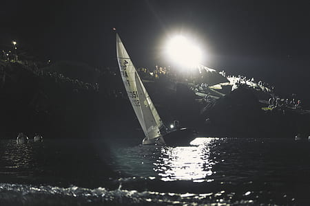 white sailboat on water during nighttime thumbnail