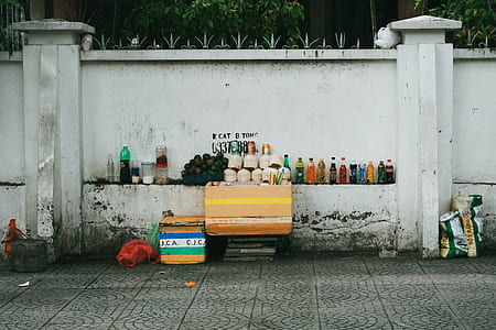 beverage bottle and fruits on wall during day thumbnail