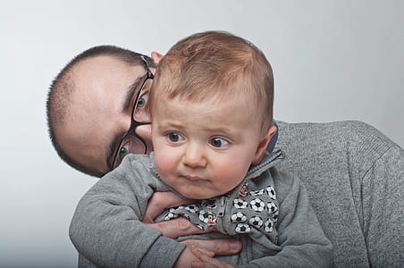 man kissing the baby on neck thumbnail