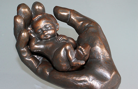 baby lying human palm figurine thumbnail