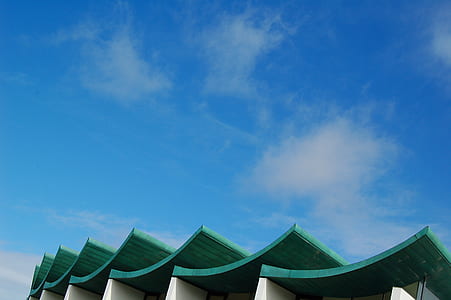 green building roofs under clear sky during daytime thumbnail