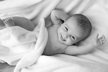 baby lying on white textile thumbnail