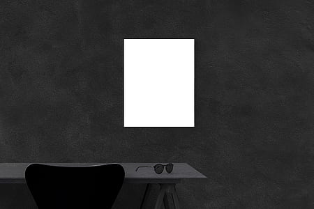 sunglasses on brown table beside black chair thumbnail