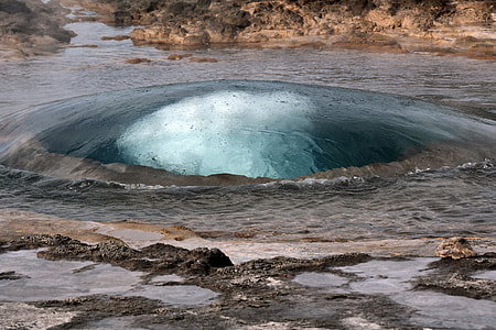 body of water beside rocks thumbnail