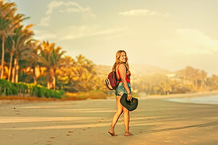 selective focus photography of woman standing on brown sand thumbnail