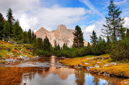 brown mountain near body of water thumbnail