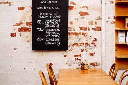 two brown wooden chair with four chairs near menu board thumbnail