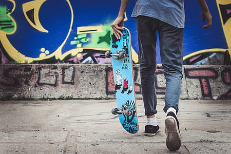 man holding skateboard thumbnail