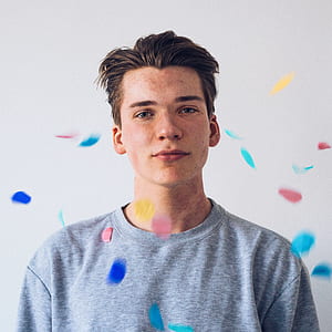 falling confetti on man in gray shirt thumbnail