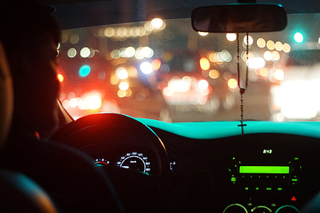 man driving car with bokeh effect thumbnail