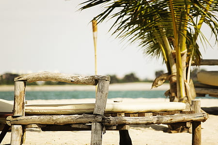 brown wooden bench near shoreline thumbnail