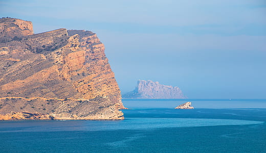 photo of rock formations near body of water thumbnail