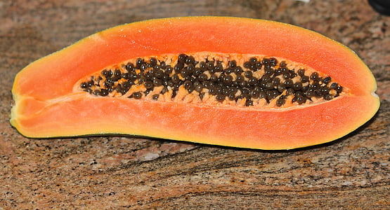 slice of papaya fruit on brown surface thumbnail