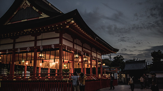 people beside brown and white building thumbnail
