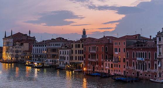 boats docked on body of water in front of houses thumbnail