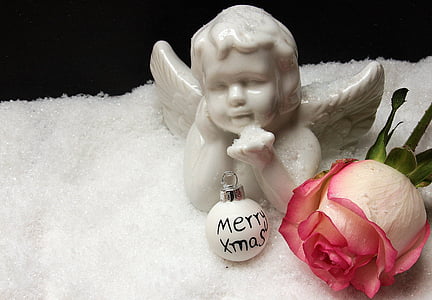 white angel ceramic figurine beside pink rose thumbnail