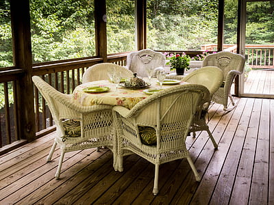 round floral dining table and four wicker armchairs thumbnail