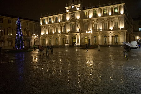 people walking near lighted building during nighttime thumbnail
