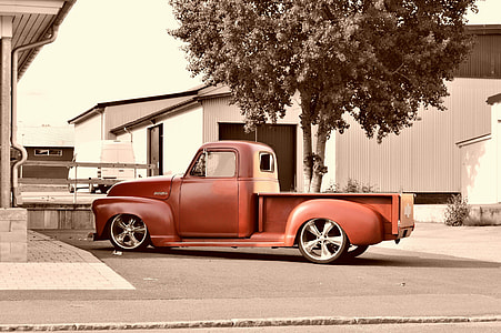 red pickup truck parked near trees thumbnail