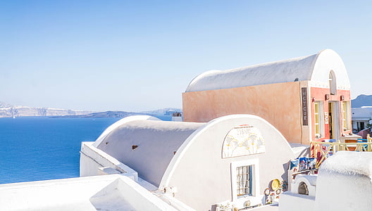 two white houses near sea at daytime thumbnail