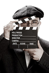 person holding white and black director's clapper board thumbnail