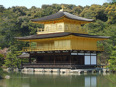yellow and black pagoda house near body of water thumbnail