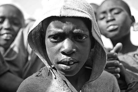 grayscale photography of boy wearing hoodie thumbnail