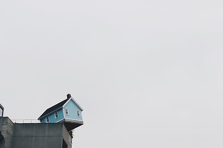 teal and black wooden house on building thumbnail