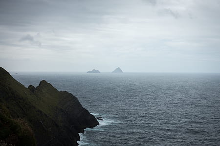 silhouette of island on body of water thumbnail