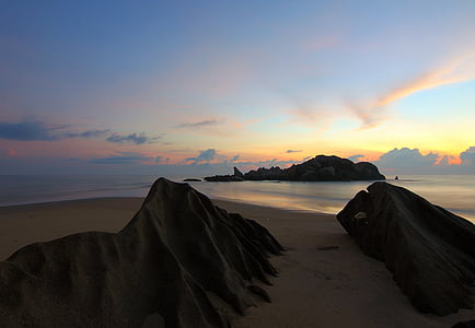 seashore with rock formations under blue sky thumbnail