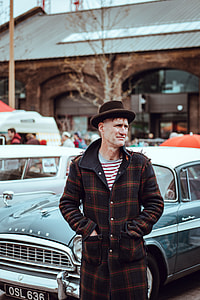man wearing brown hat behind car thumbnail