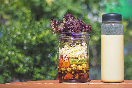 clear glass container with sliced vegetable on wooden top surface at daytime thumbnail
