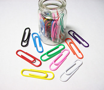 assorted-color paper clips beside glass bottle thumbnail